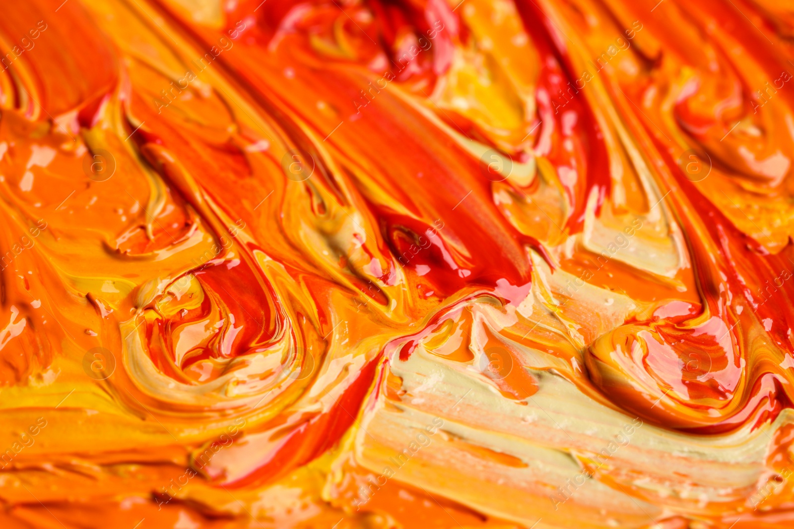 Photo of Beautiful strokes of colorful oil paints as background, closeup