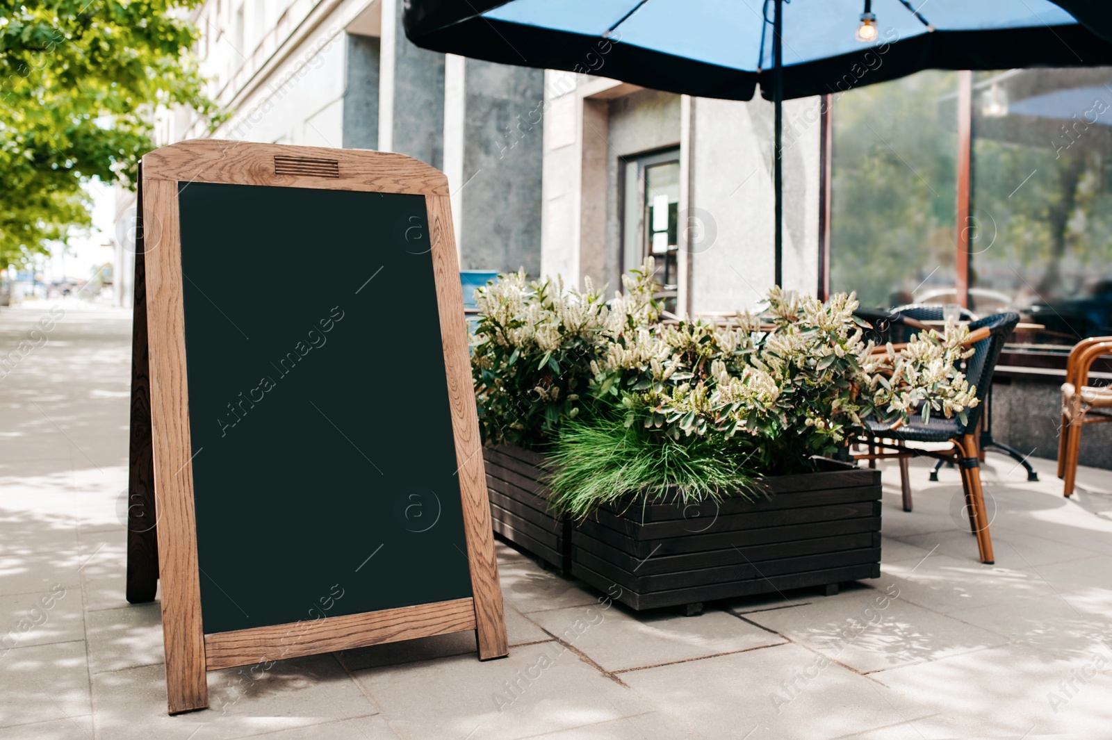 Photo of Blank advertising board on city street. Space for design