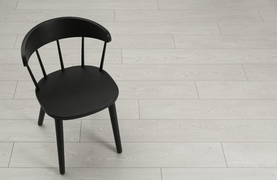 Photo of Stylish wooden chair on floor. Space for text
