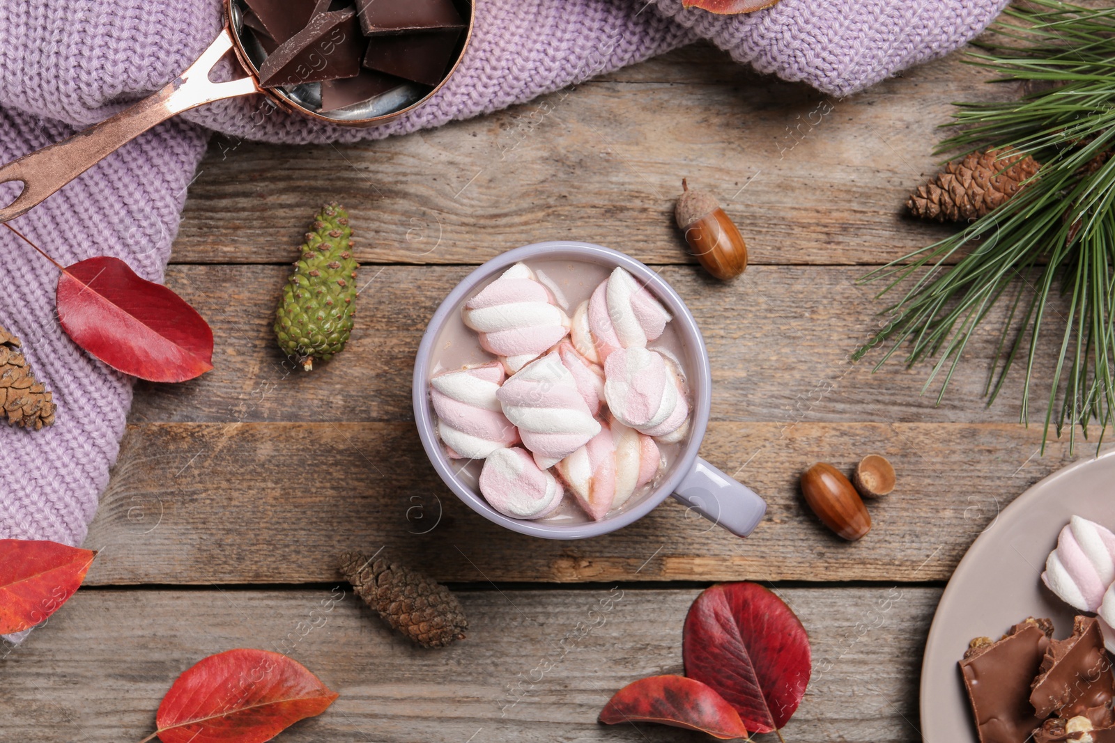 Photo of Flat lay composition with hot cozy drink and autumn leaves on wooden background