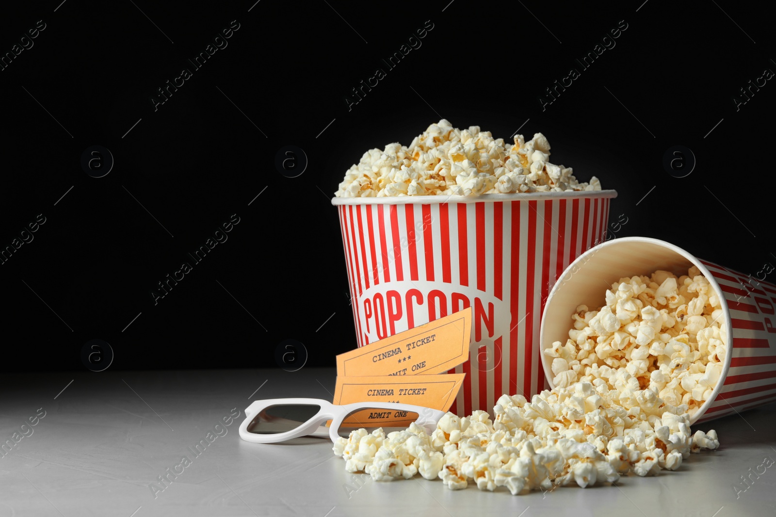 Photo of Popcorn, cinema tickets and 3d glasses on grey table. Space for text