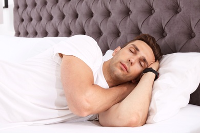 Young man sleeping in bed at home