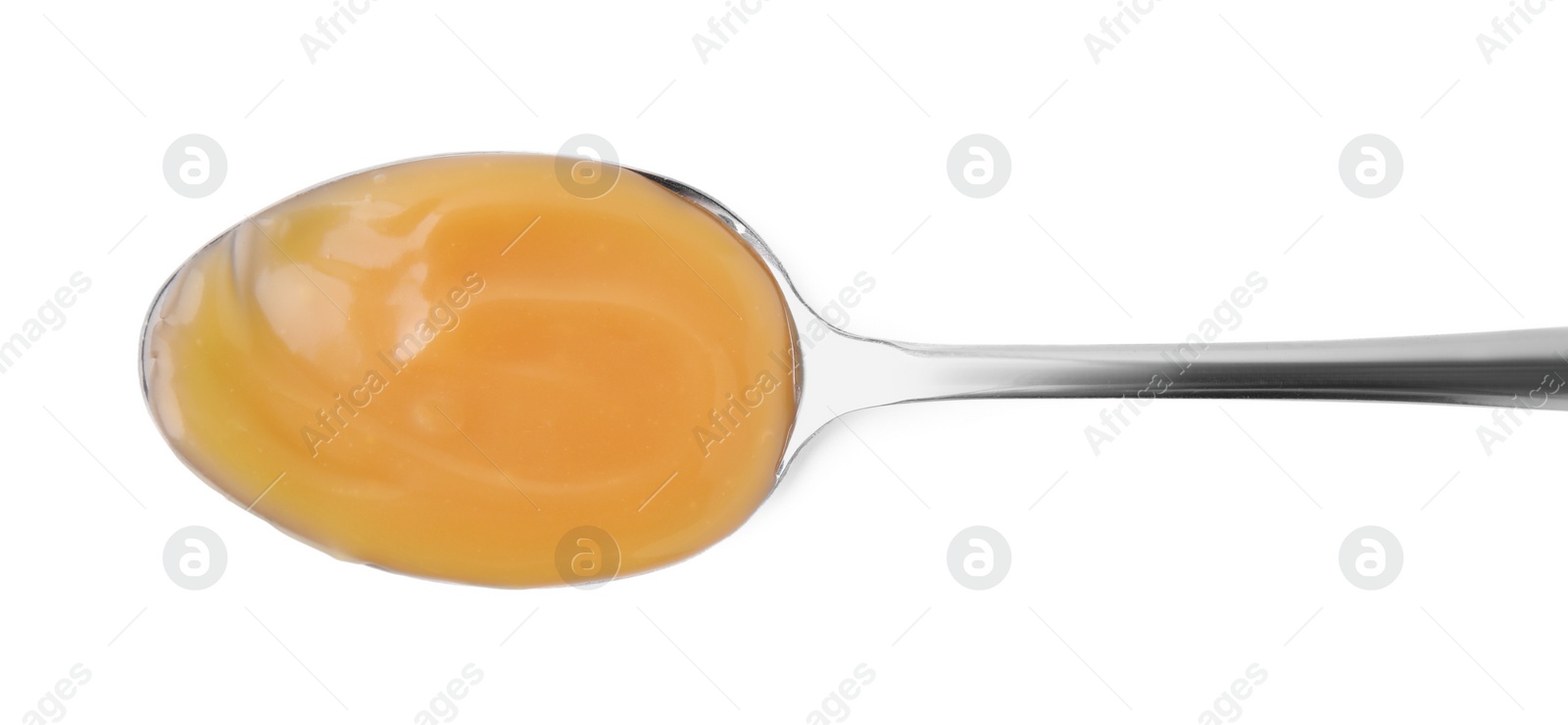 Photo of Spoon with tasty salted caramel isolated on white, top view