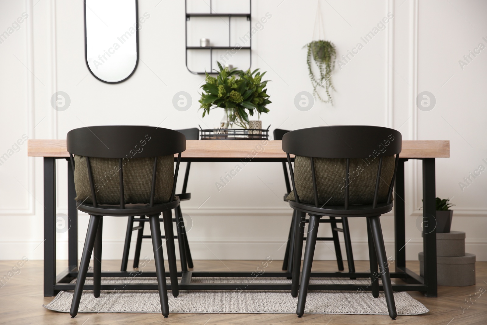 Photo of Stylish wooden dining table and chairs in room. Interior design