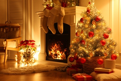Photo of Fireplace with Christmas stockings in beautifully decorated living room
