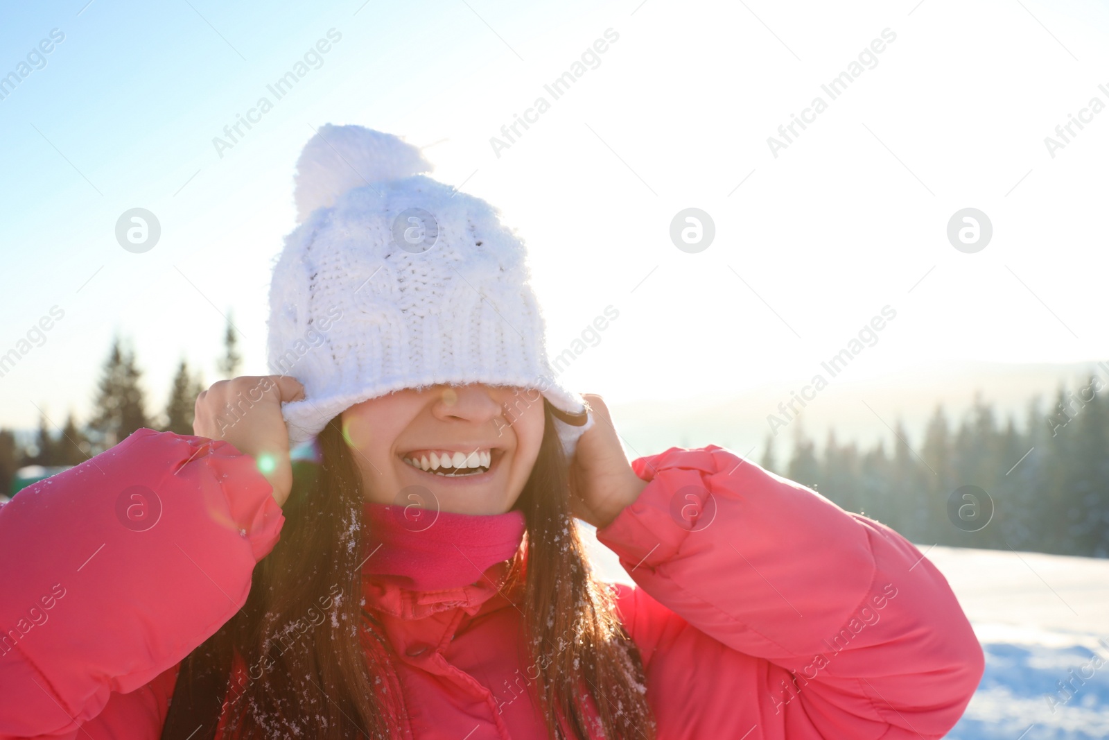 Photo of Young woman having fun outdoors on snowy winter day