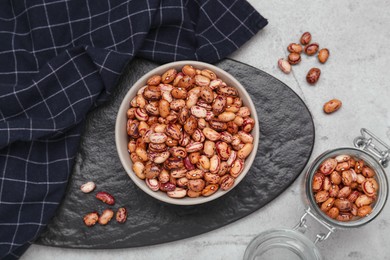 Photo of Many dry kidney beans on light grey table, flat lay