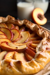 Photo of Delicious fresh peach pie on table, closeup