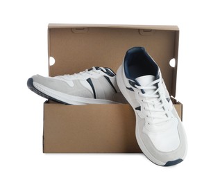 Photo of Pair of stylish sport shoes and cardboard box on white background