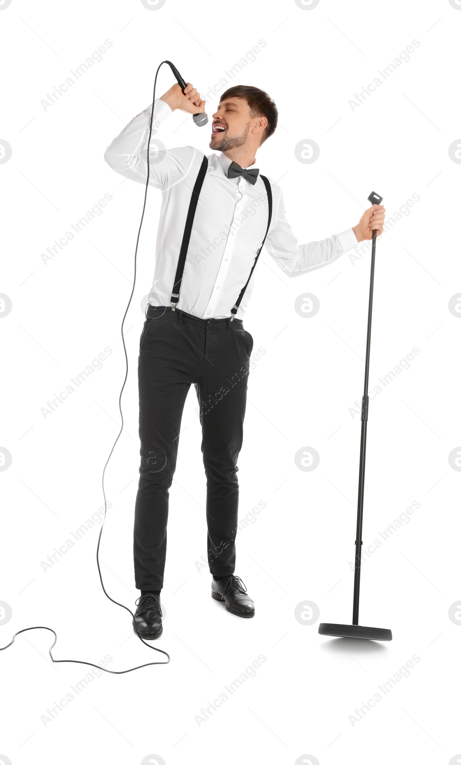 Photo of Handsome man in formal clothes singing with microphone on white background