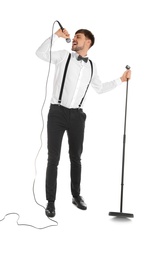 Photo of Handsome man in formal clothes singing with microphone on white background