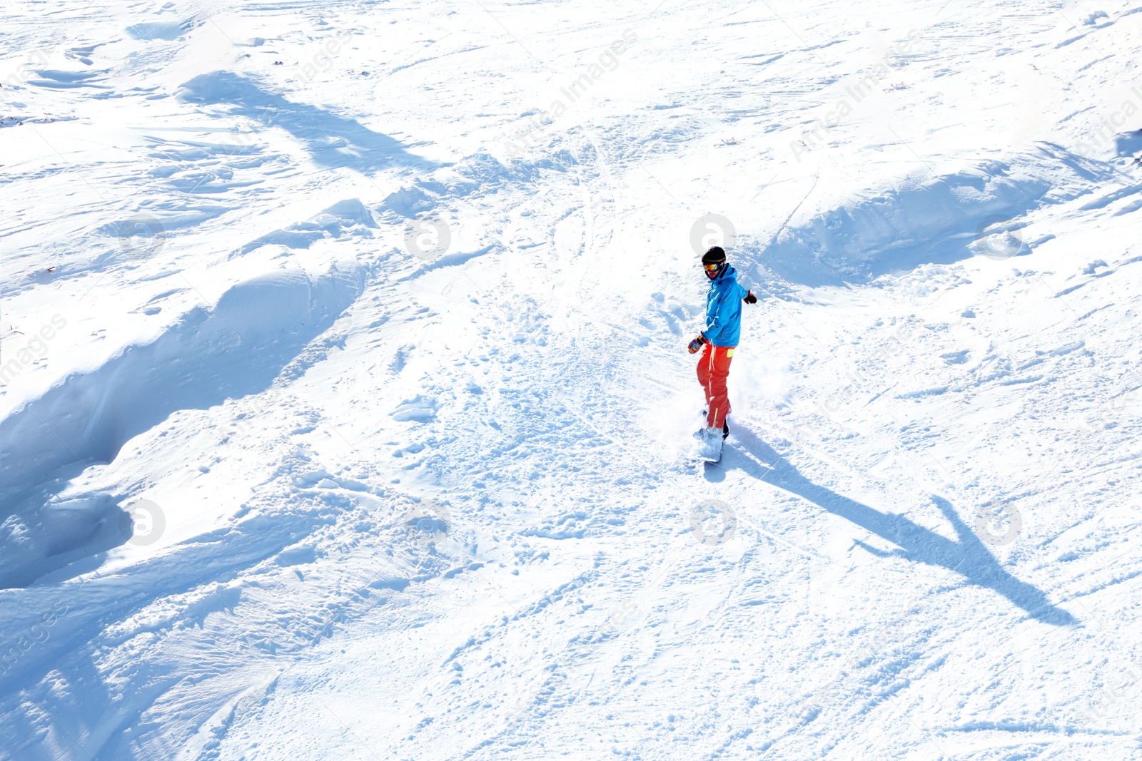 Photo of Male skier on slope at resort. Winter vacation