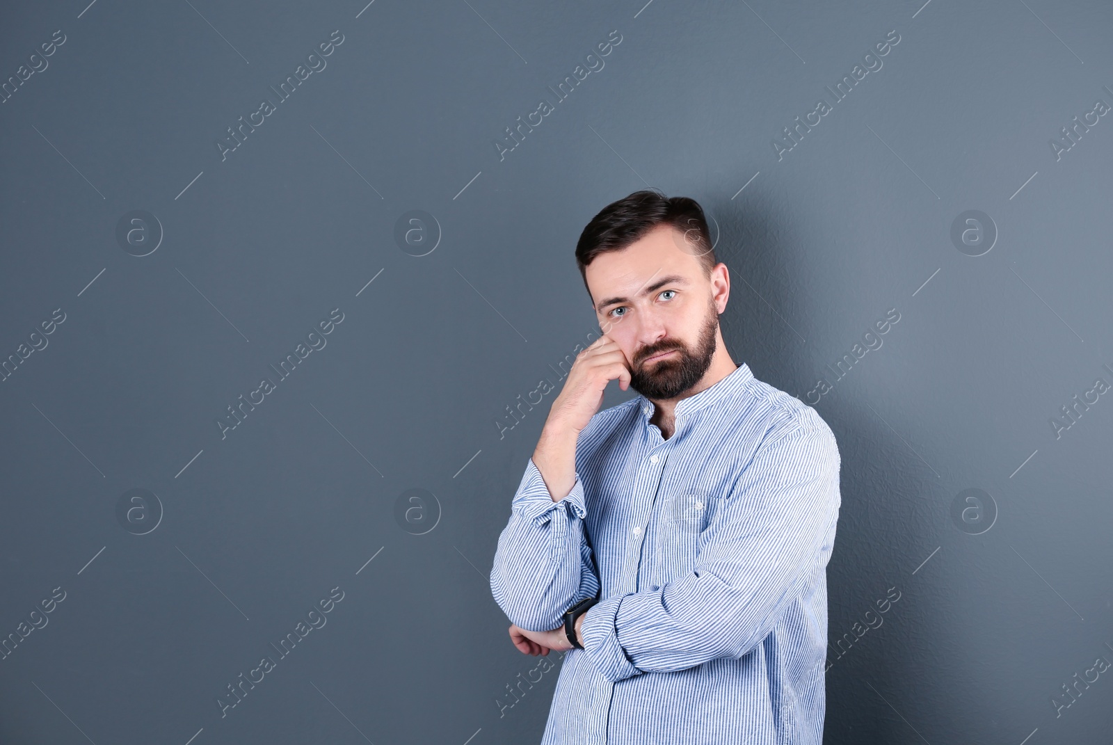 Photo of Portrait of handsome bearded man on color background