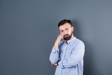 Portrait of handsome bearded man on color background