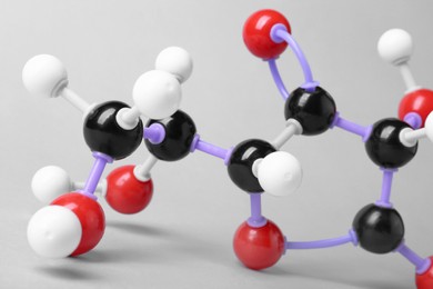 Photo of Molecule of vitamin C on light grey background, closeup. Chemical model