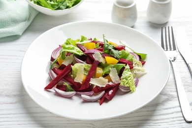 Plate with delicious beet salad served on table