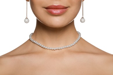 Young woman wearing elegant pearl jewelry on white background, closeup