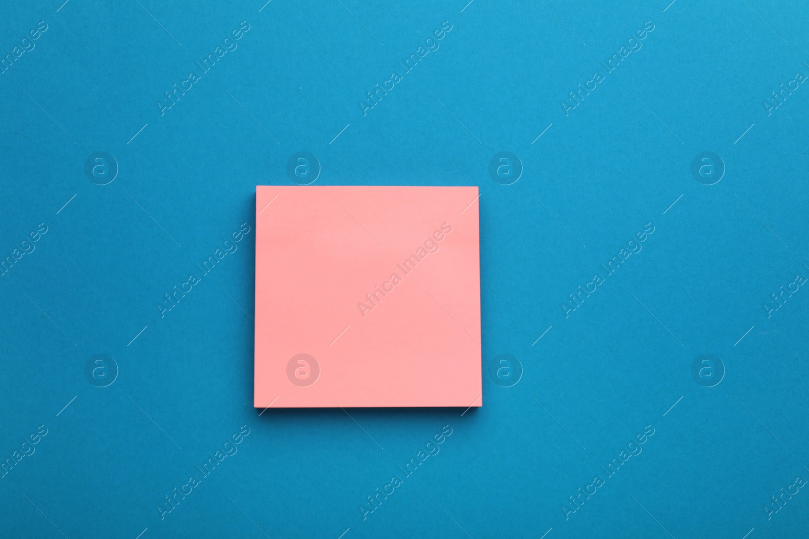 Photo of Paper note on blue background, top view