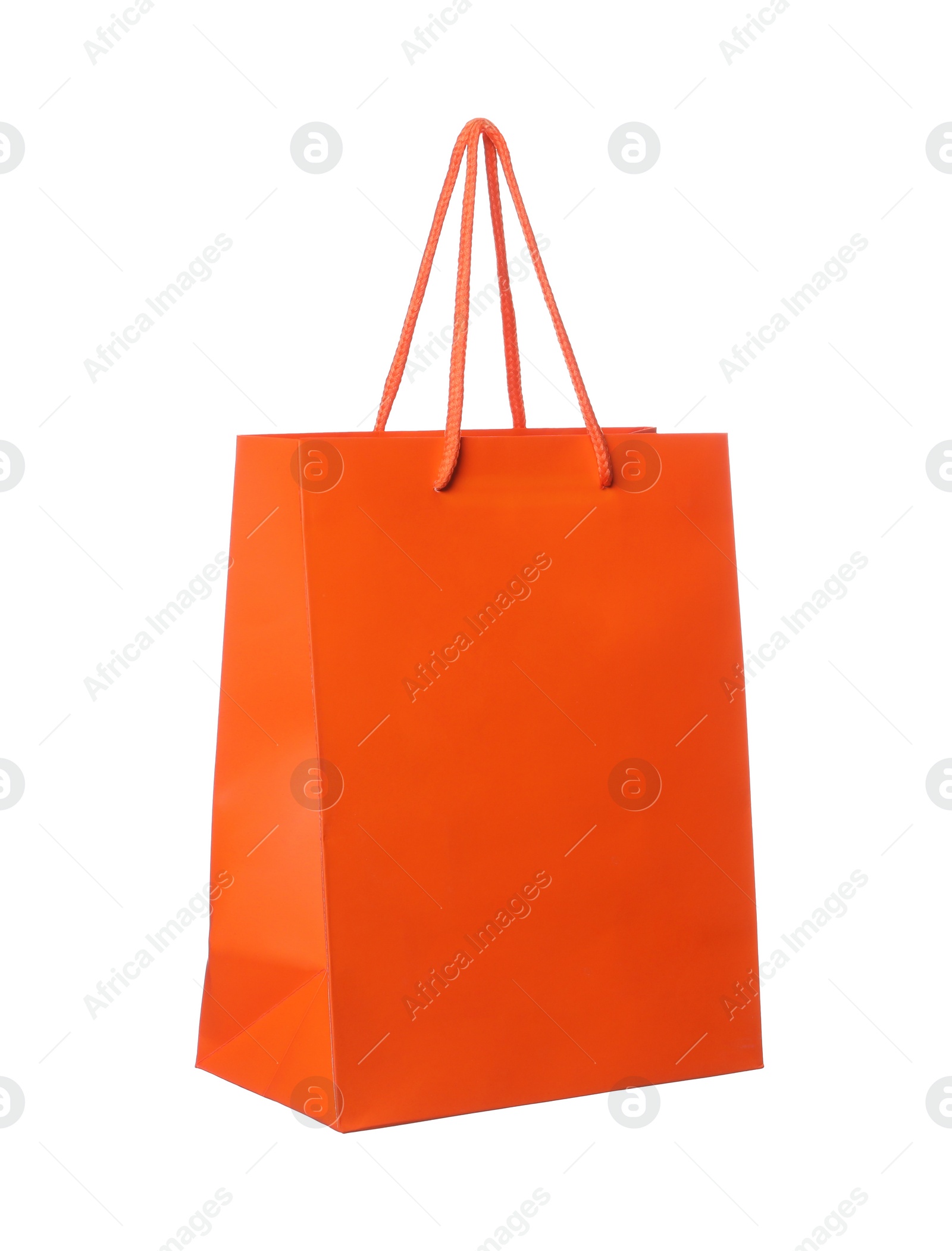 Photo of One orange shopping bag isolated on white