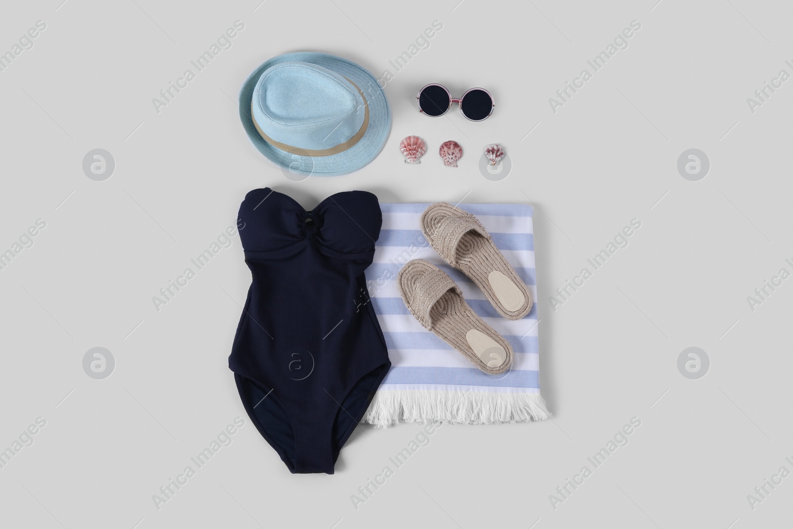 Photo of Flat lay composition with beach accessories on white background