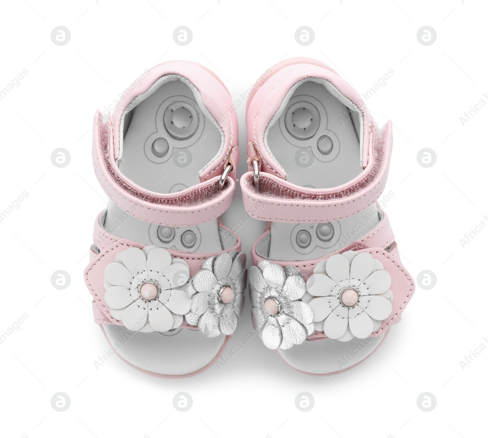 Photo of Pair of cute baby sandals decorated with flowers on white background, top view