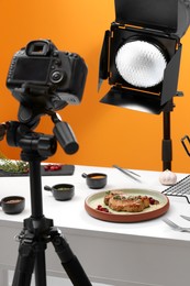 Professional equipment and composition with delicious meat medallion on white table in studio. Food photography