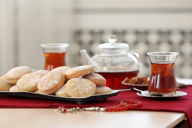 Traditional cookies for Islamic holidays and tea on table. Eid Mubarak