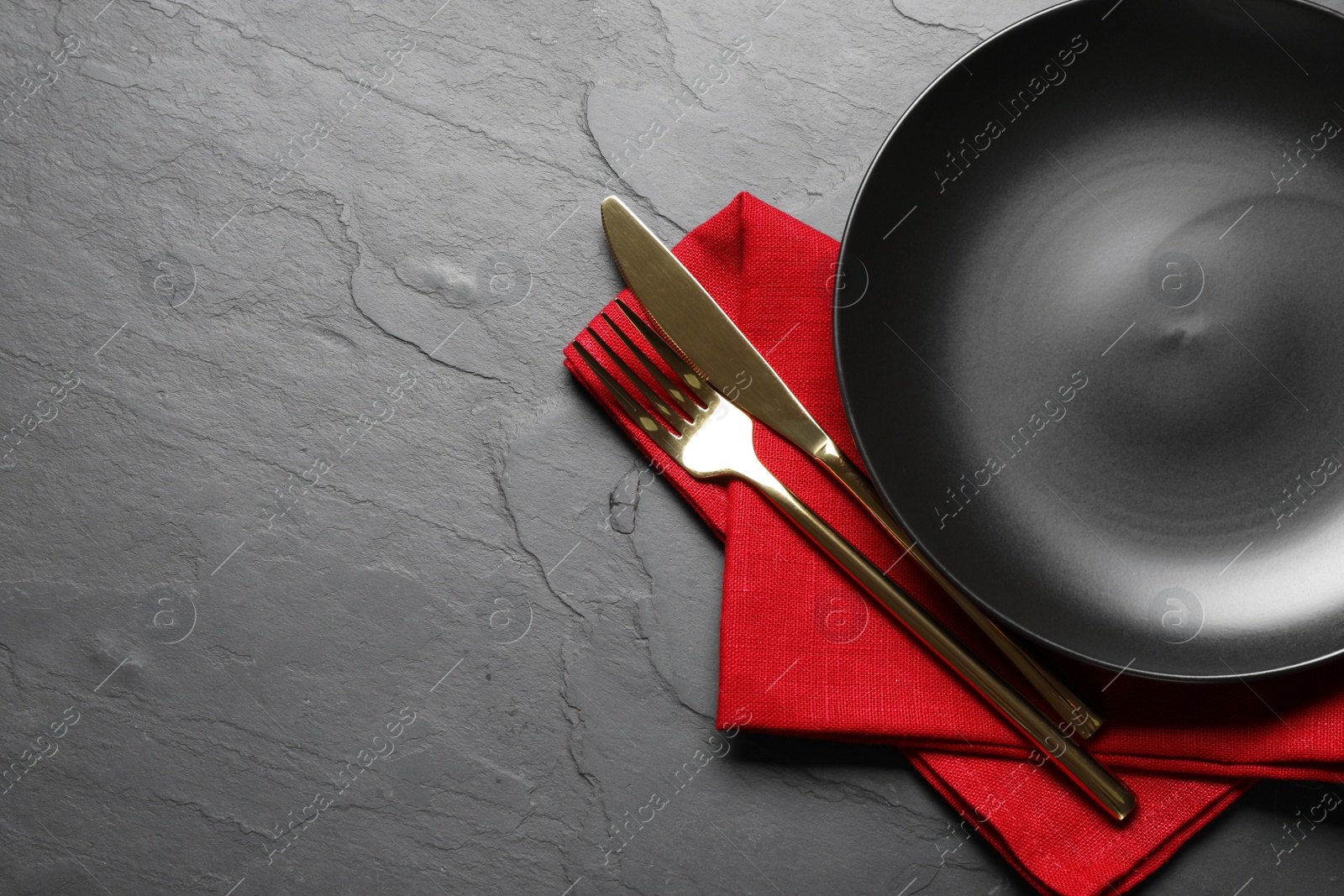 Photo of Beautiful table setting on black background, top view. Space for text