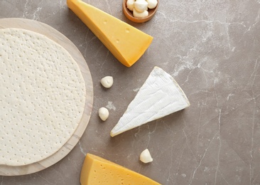 Photo of Flat lay composition with pizza crust and fresh ingredients on table