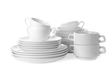 Photo of Set of clean tableware isolated on white