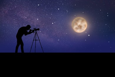 Astronomer looking at moon and stars through telescope outdoors