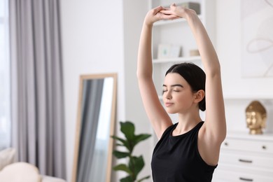 Photo of Portrait of beautiful girl practicing yoga at home