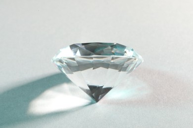 Photo of Beautiful dazzling diamond on white background, closeup
