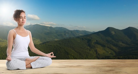 Image of Young African American woman practicing yoga on wooden surface against beautiful mountain landscape, space for text. Banner design