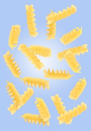 Image of Raw fusilli pasta flying on blue background