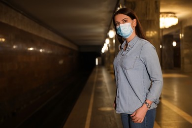 Woman with medical mask waiting for train on subway station. Public transport
