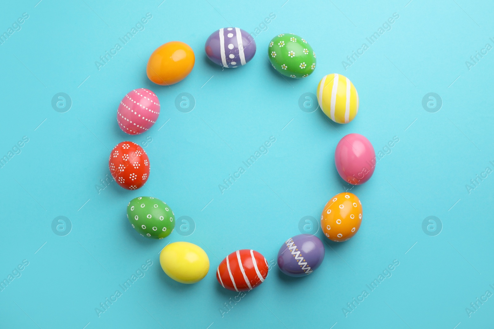 Photo of Decorated Easter eggs and space for text on color background, top view