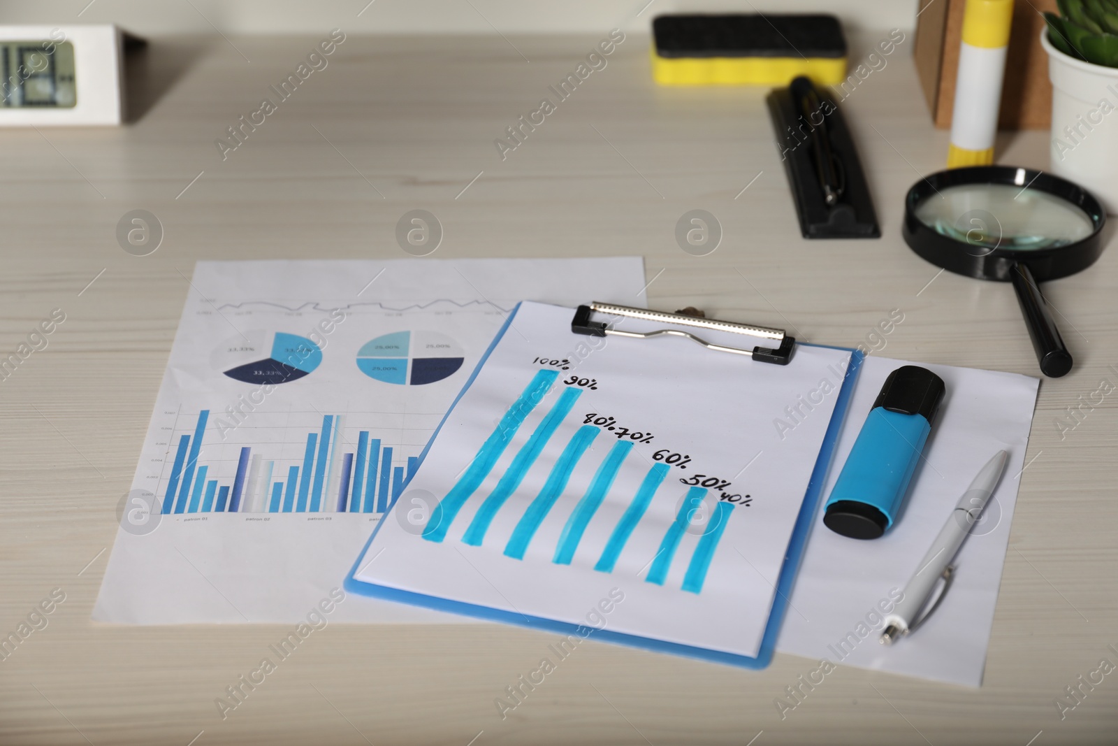 Photo of Business process planning and optimization. Workplace with different graphs and other stationery on wooden table