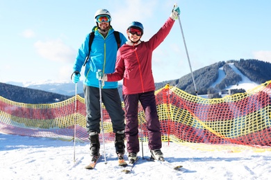 Couple spending winter vacation at mountain ski resort