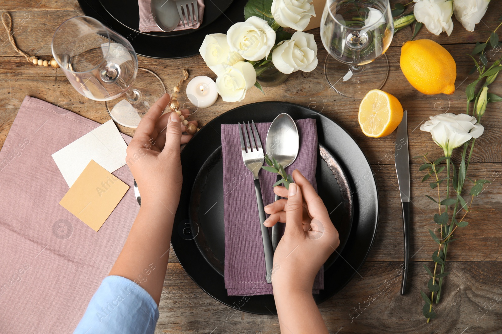 Photo of Woman setting table for festive dinner, top view