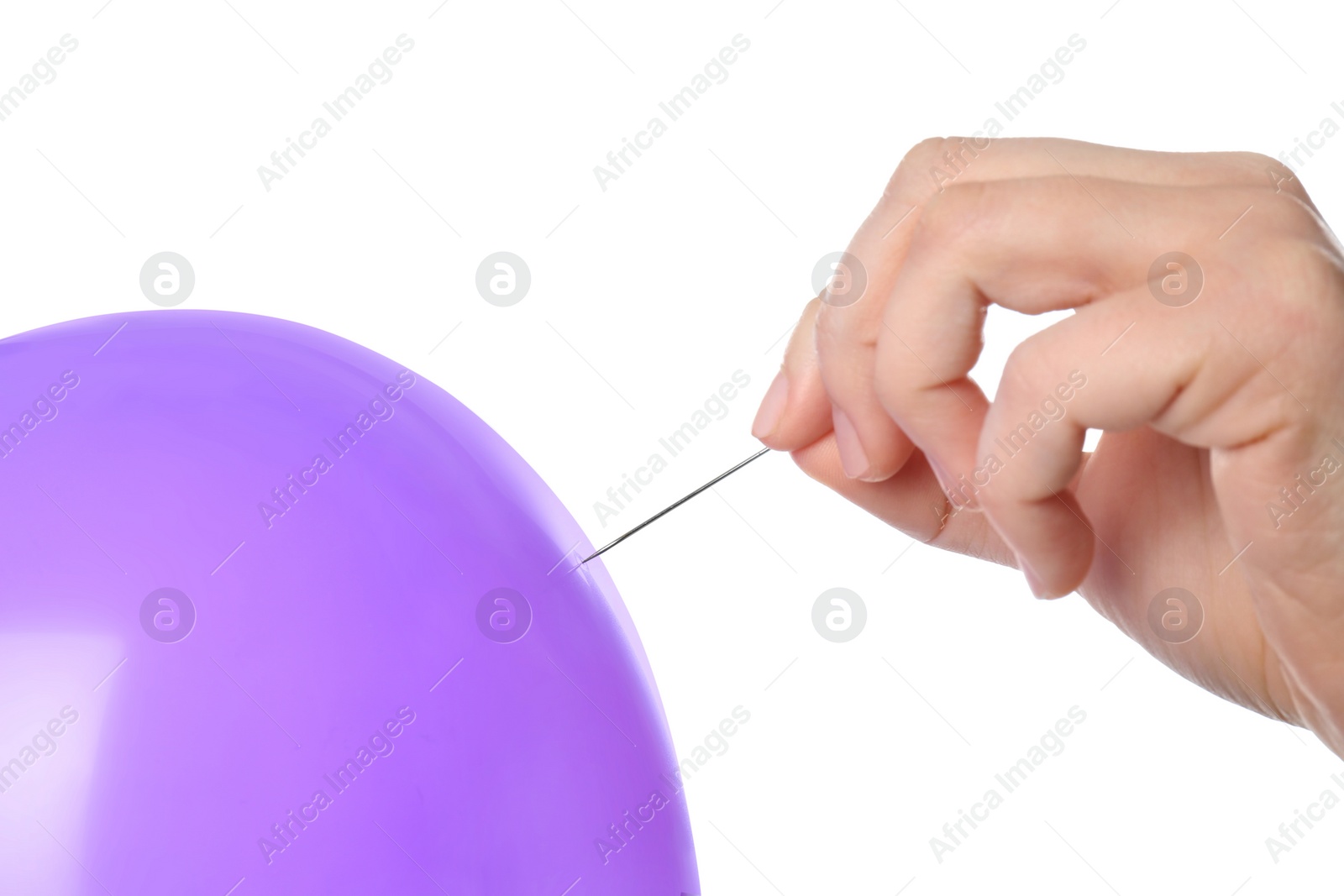 Photo of Woman piercing purple balloon on white background, closeup