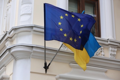 Photo of Flags of Ukraine and European Union on building facade