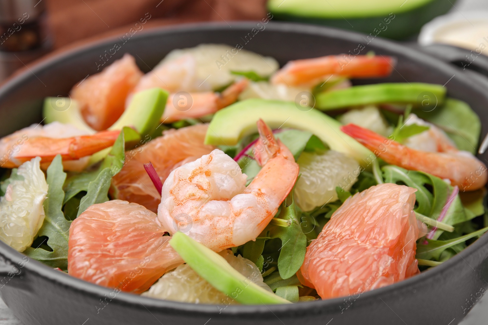 Photo of Delicious pomelo salad with shrimps on table, closeup view