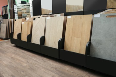 Photo of Many different samples of wooden flooring in store