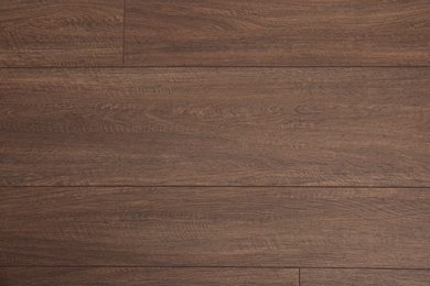 Photo of Clean wooden laminate as background, top view. Floor covering