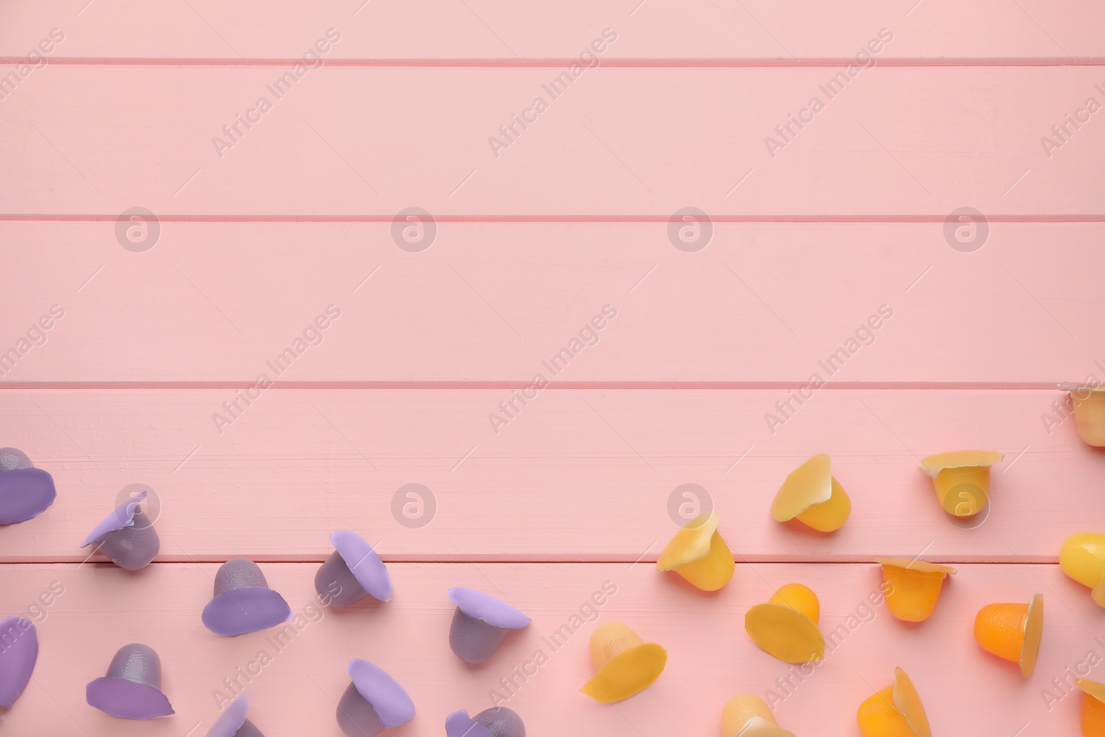 Photo of Tasty bright jelly cups on pink wooden table, flat lay. Space for text