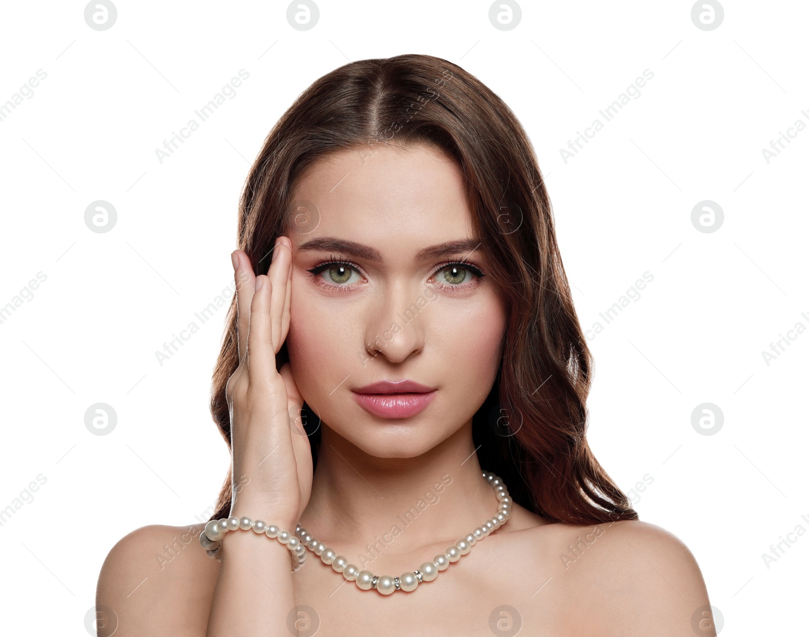 Photo of Young woman wearing elegant pearl jewelry on white background