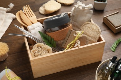 Photo of Crate with eco friendly products on wooden table