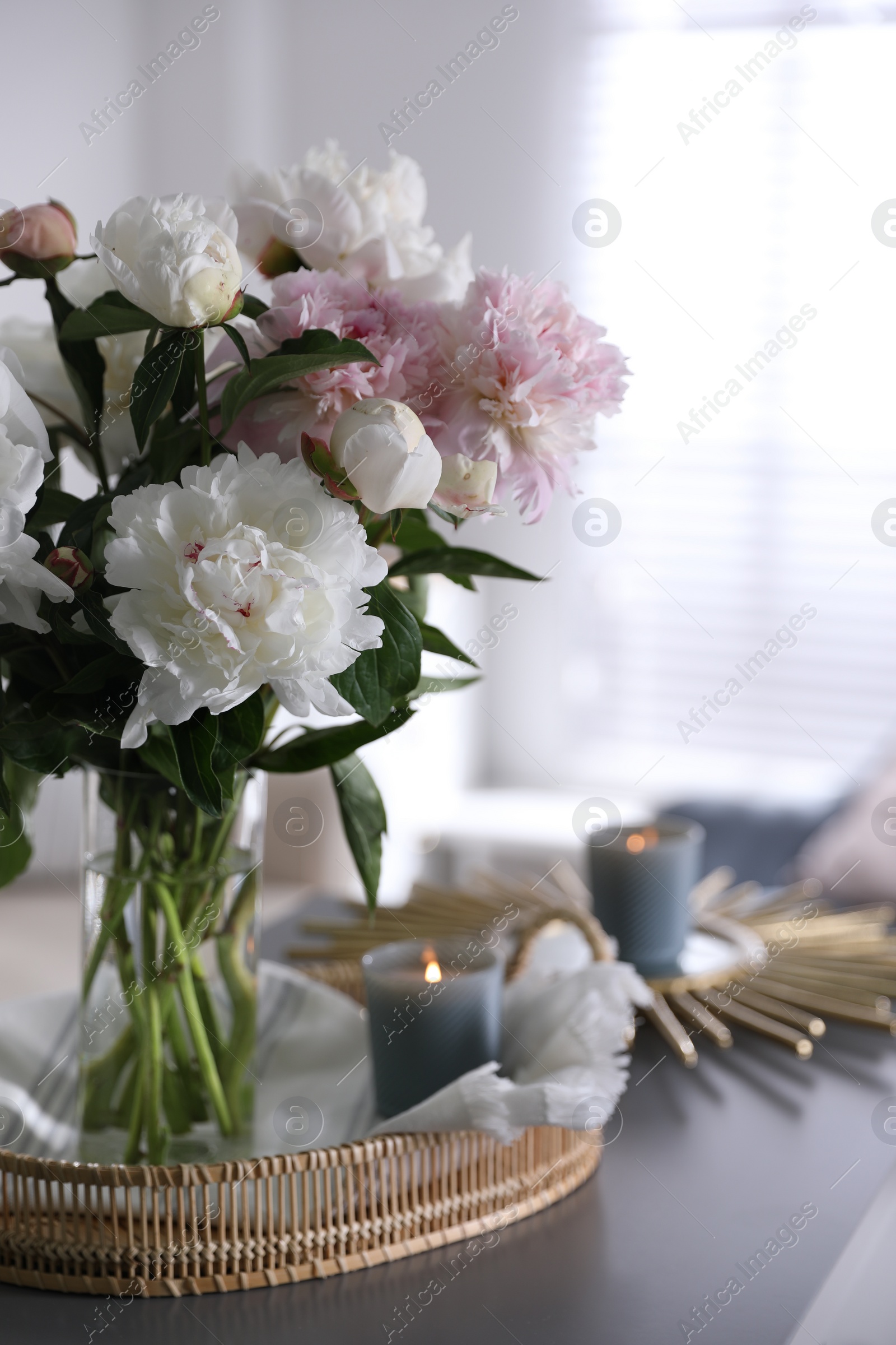 Photo of Bouquet of beautiful peony flowers on table indoors