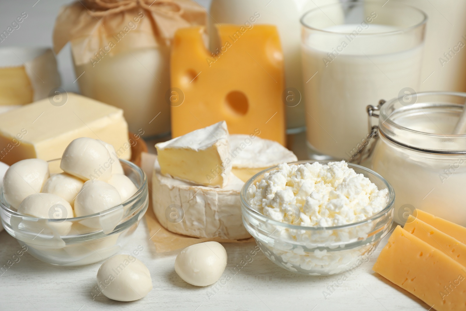 Photo of Different delicious dairy products on white table